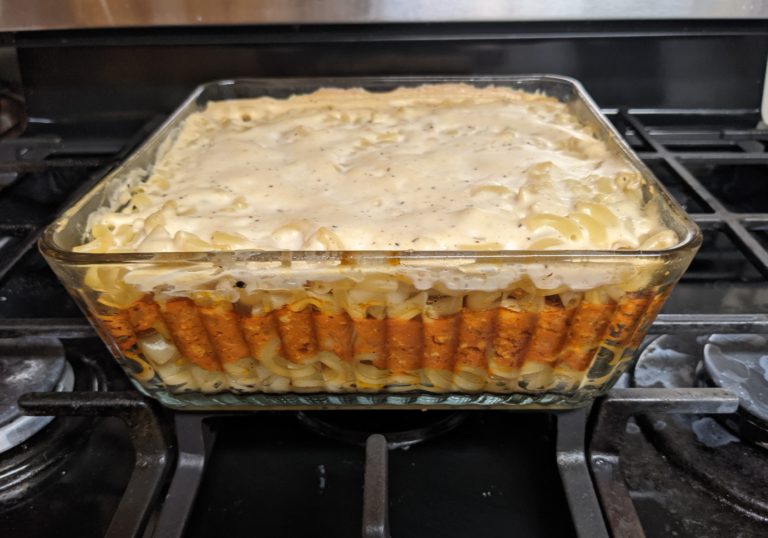 Casserole dish with noodles, sauce, and bechamel layers