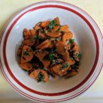 Bowl of steamed carrots with herbs and spices